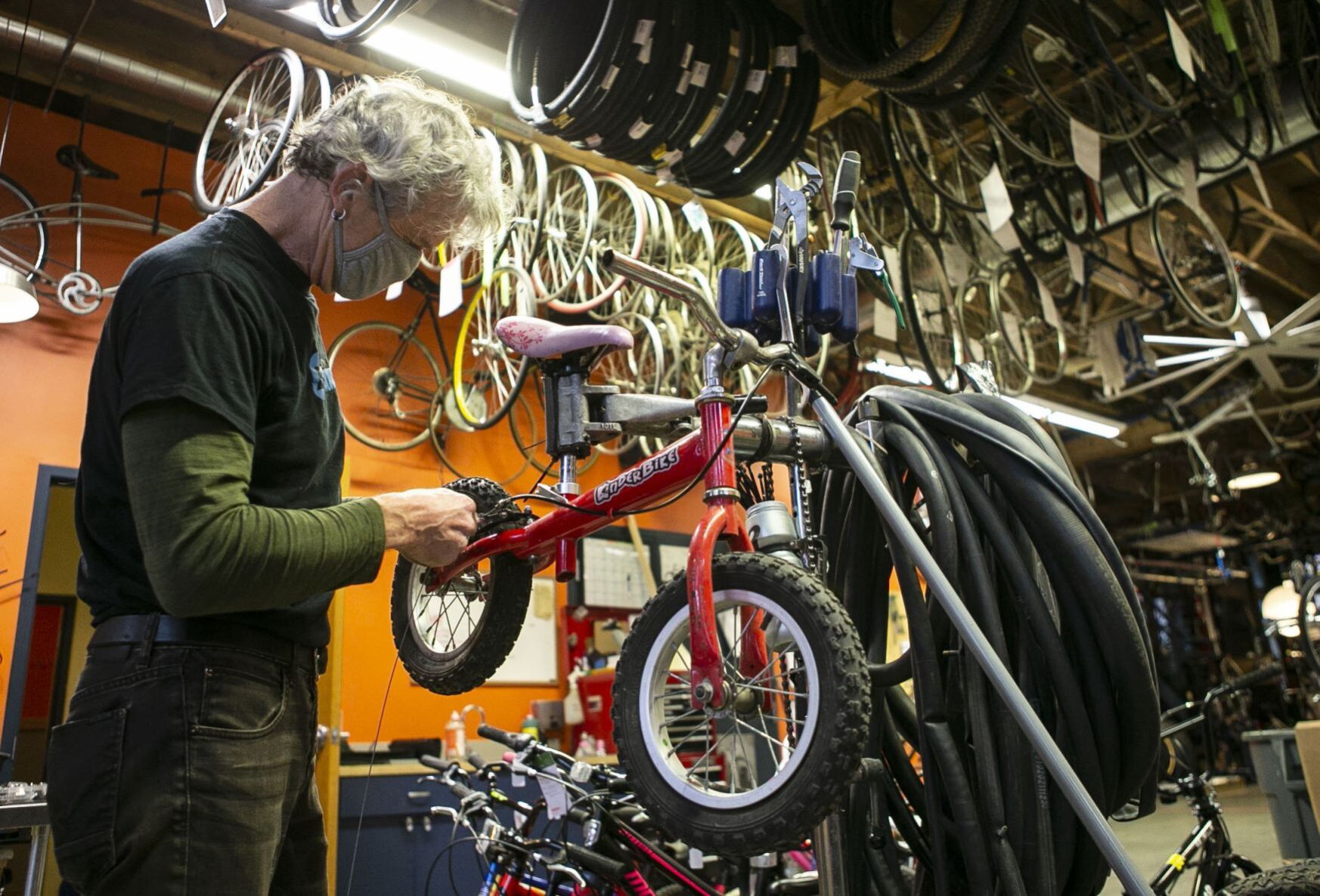 Volunteers and employees repair bikes at St. Louis BWorks in Soulard